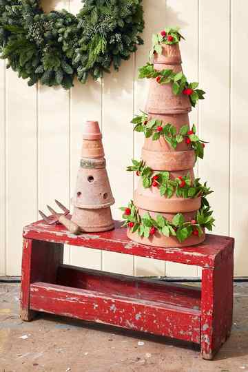 a stack of terracotta pots transormed into a christmas tree display