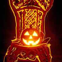 Carved smiling pumpkin on chair by Garry Gay