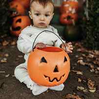 Adorable Toddler Boy Dressed Up As Mummy On Halloween Trick-or-treat by Cavan Images